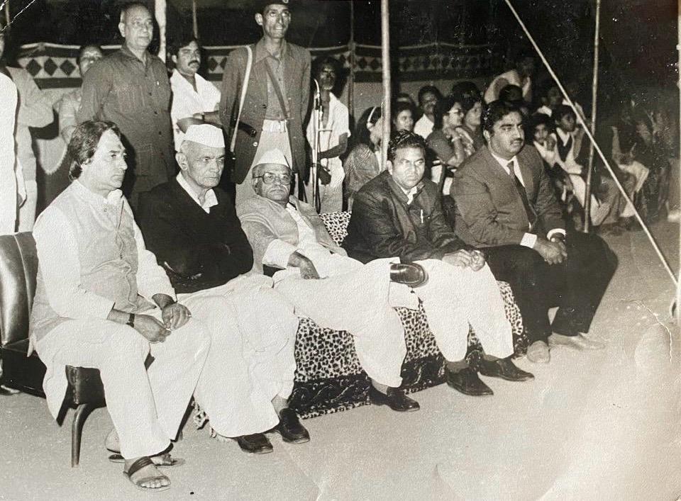 Shri Hanuman Singh Ji seated at a public event